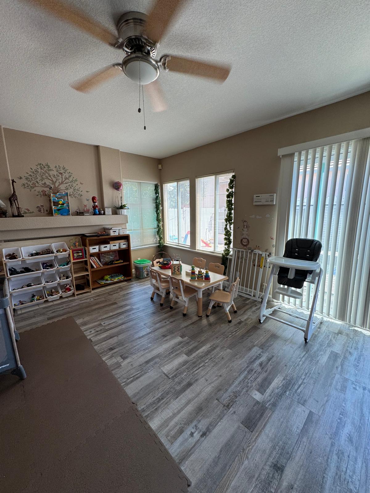 Children's activity table set up for art and play with bookshelf nearby