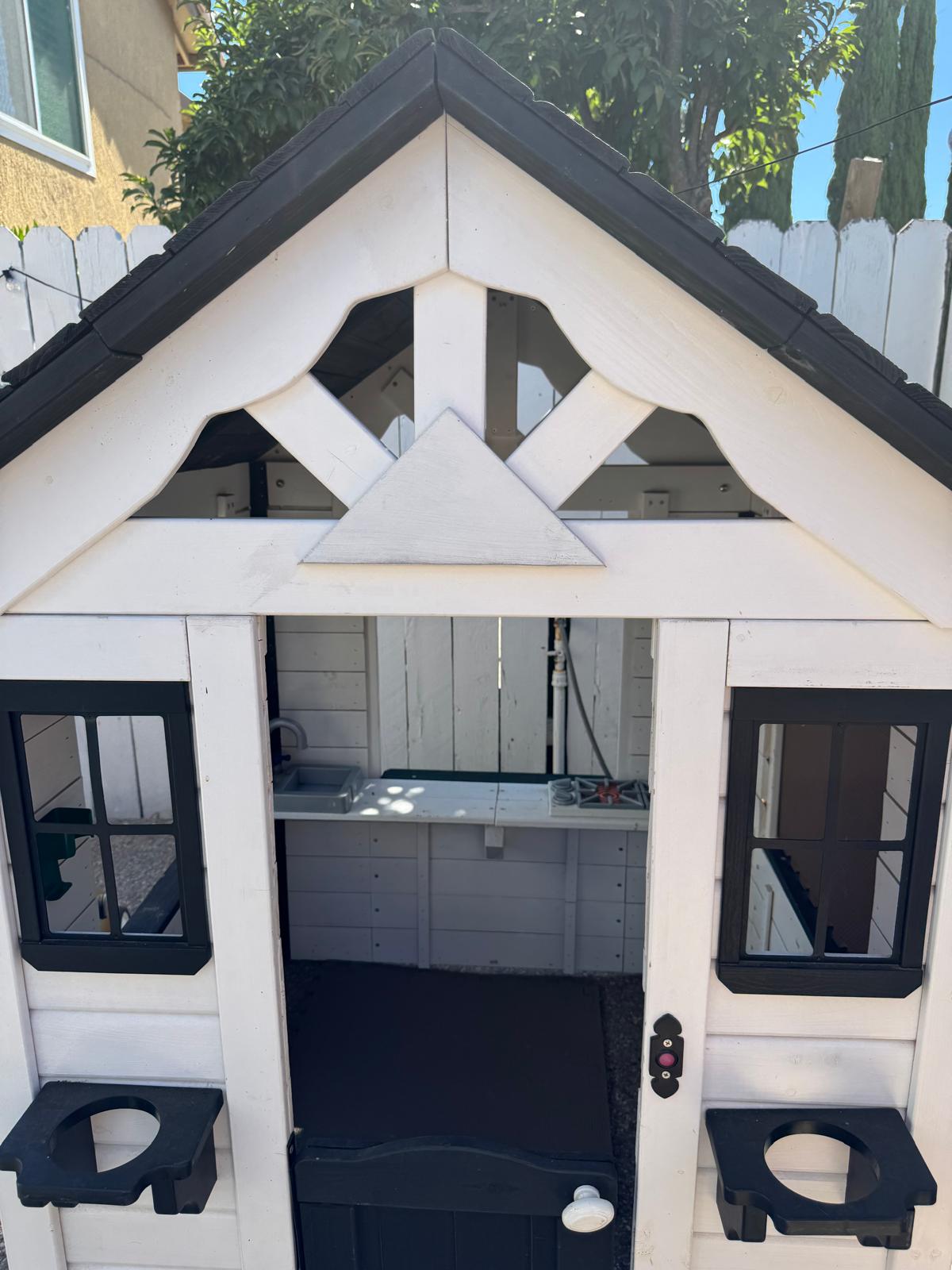 Outdoor playhouse with a pretend kitchen for hands-on, real-life play