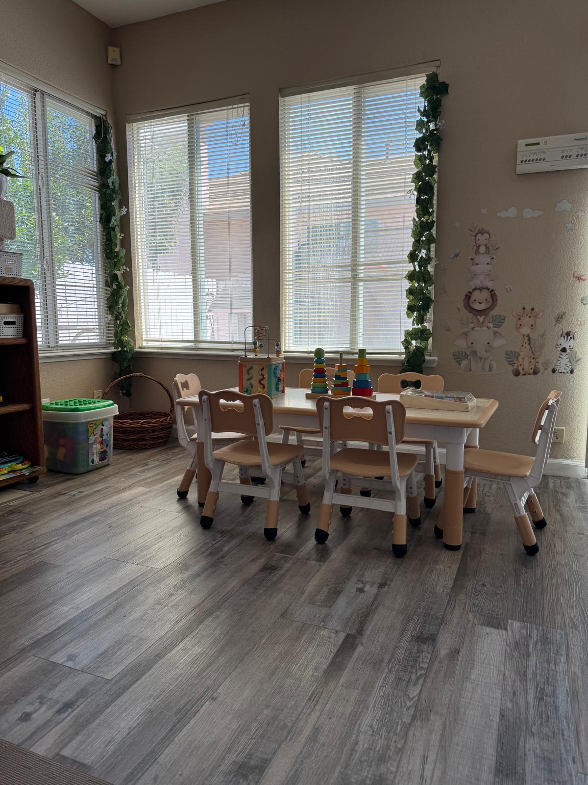 Children's activity table with chairs near sunlit windows